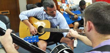 Guy learning guitar
